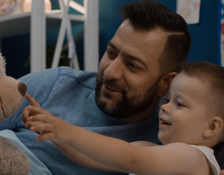 Man with little son playing with toy