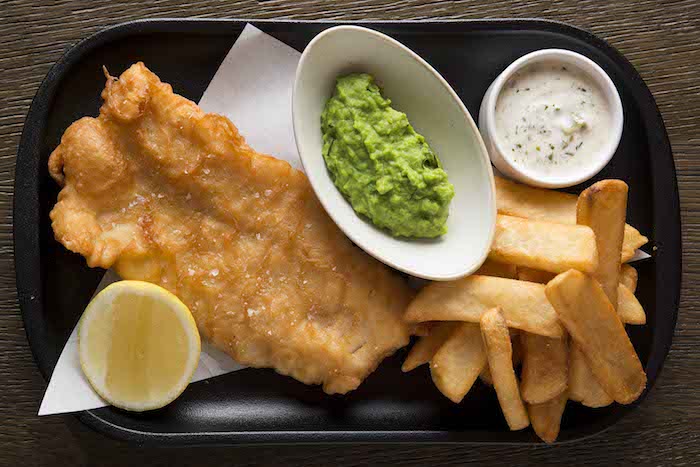 Traditional fish and chips, crushed peas, tartar sauce