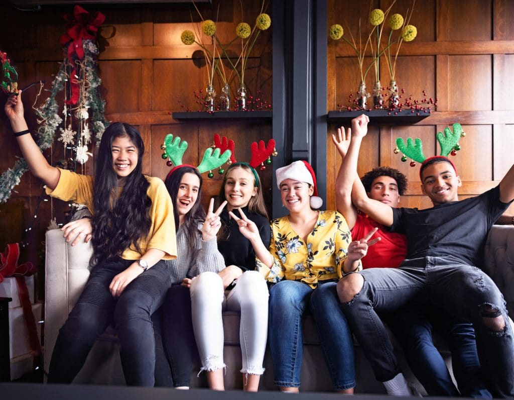 Generation z Christmas party with multi-ethnic friends