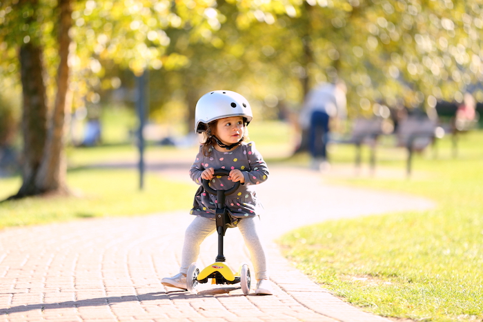 little girl on a micro scooter