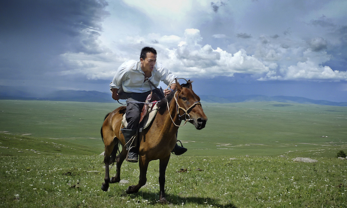Albert Lin on horseback, Mongolia_CR Mike Hennig