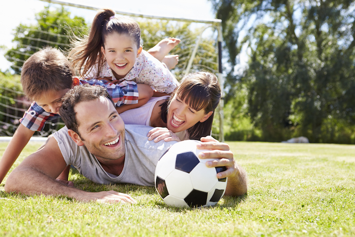 active family playing sports soccer