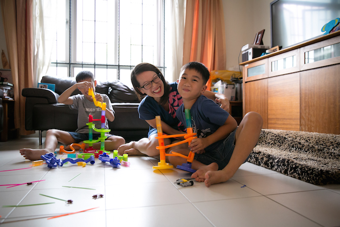 that mama yen siow plays with two of her sons