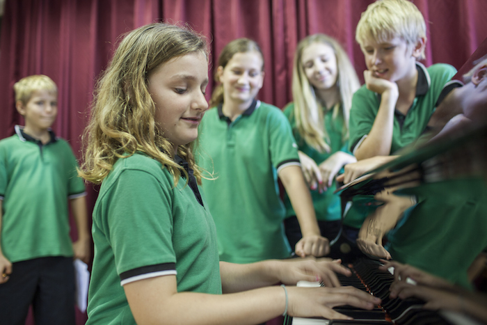 playing the piano in a performance cca at gess