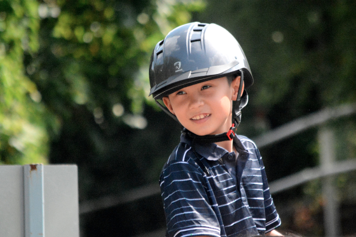 A child with special needs takes equine assisted therapy classes