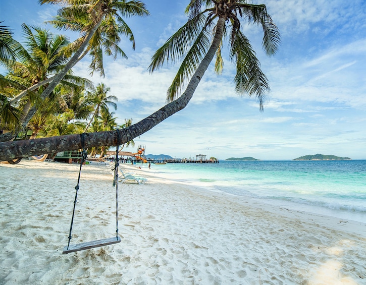 beach swing and white sand at rawa island resort