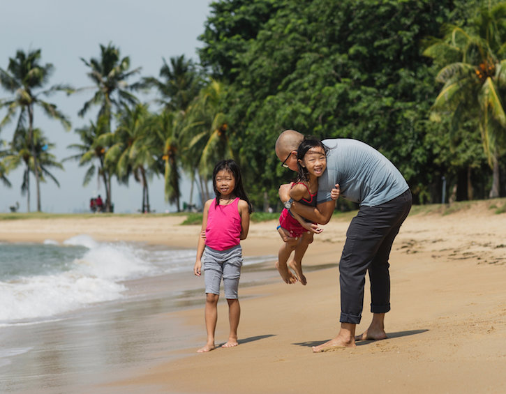 Andy Chen at the beach with his daughters in Singapore