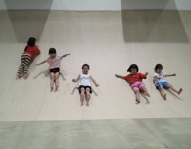 artground indoor play childrens theatre kids on a slide rolling at TAG