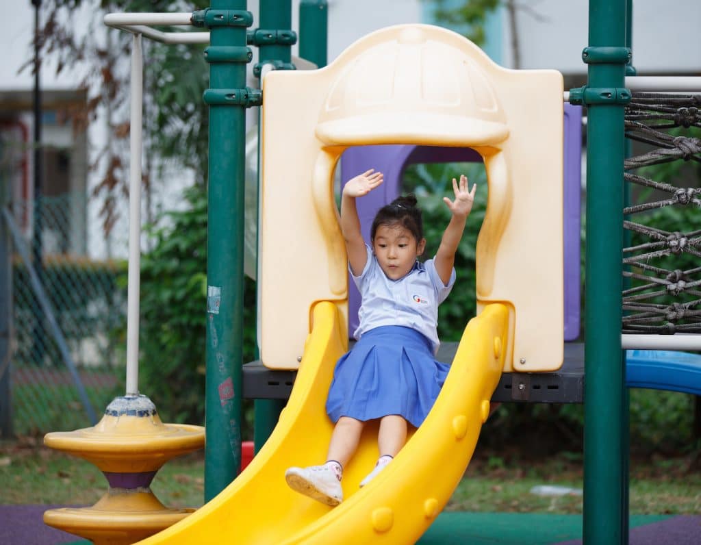 a happy student on the playground at giis