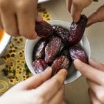 Middle Eastern family sharing and eating dates together