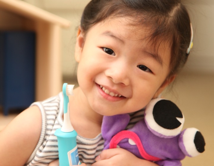 Orthodontist Singapore - Raintree Dental - child with toothbrush