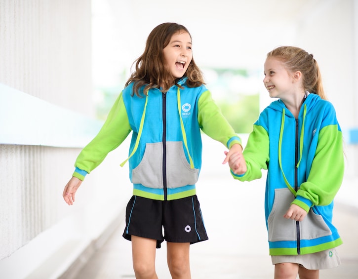 photo of two friends holding hands at nexus international school