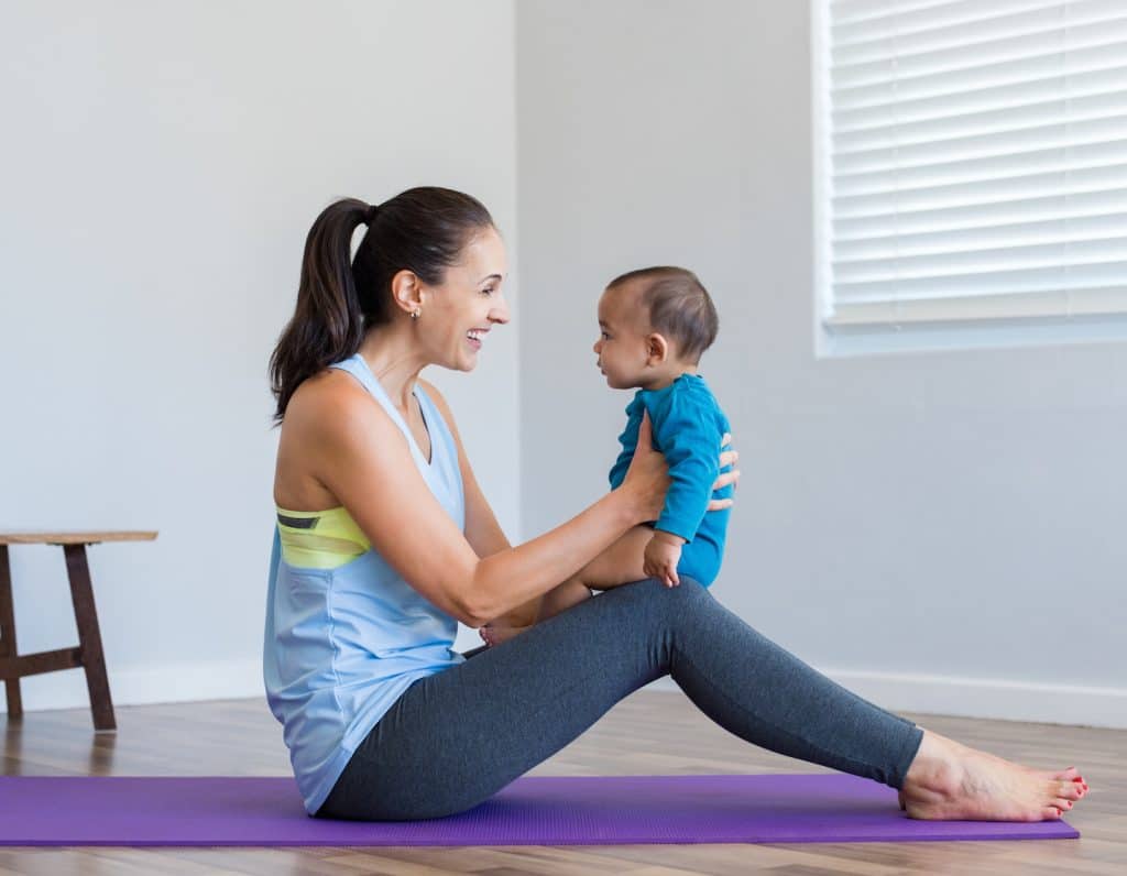 Woman doing yoga with son