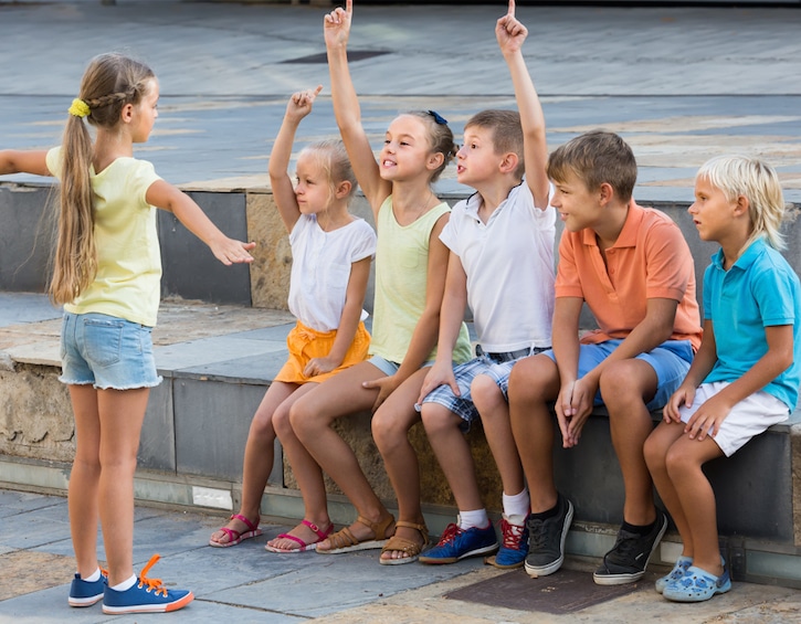 kids playing charades outdoors