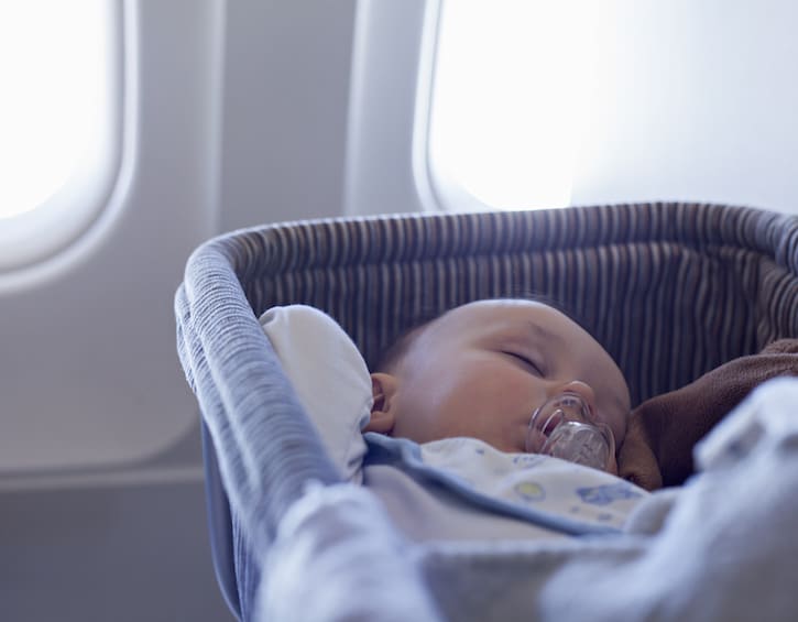 Baby Boy Sleeping In Bassinet On Airplane