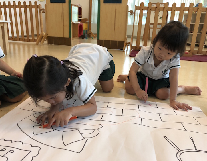 kids drawing at raffles montessori kindergarten aljunied