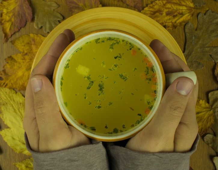 cup of hot soup warming hands