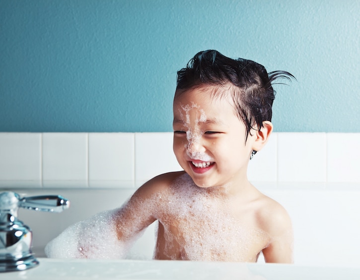 Asian Boy Taking a Bath and Smiling
