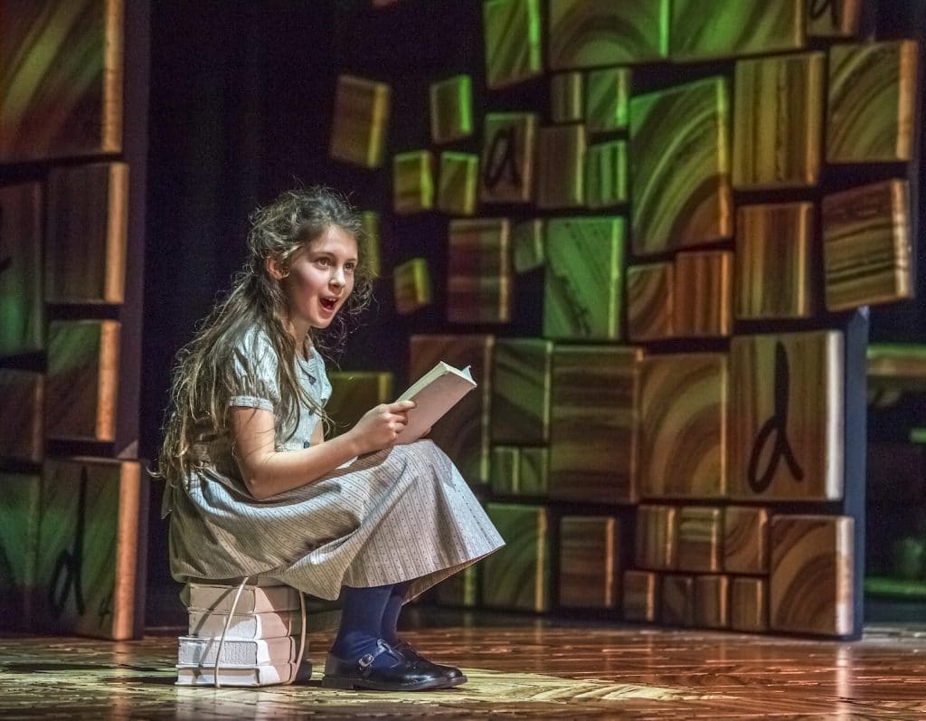 matilda sings in front of her beloved books in matilda the musical