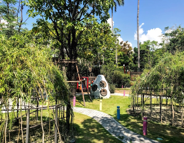 outdoor space at the rosewood phuket kids club includes teepees and a "sound hive"