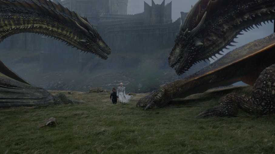 Danaerys Targaryen and Tyrion Lannister with two of her dragons on game of thrones