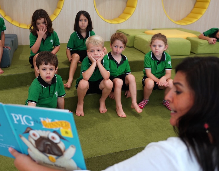 GESS preschool students enjoy reading aloud from their teacher