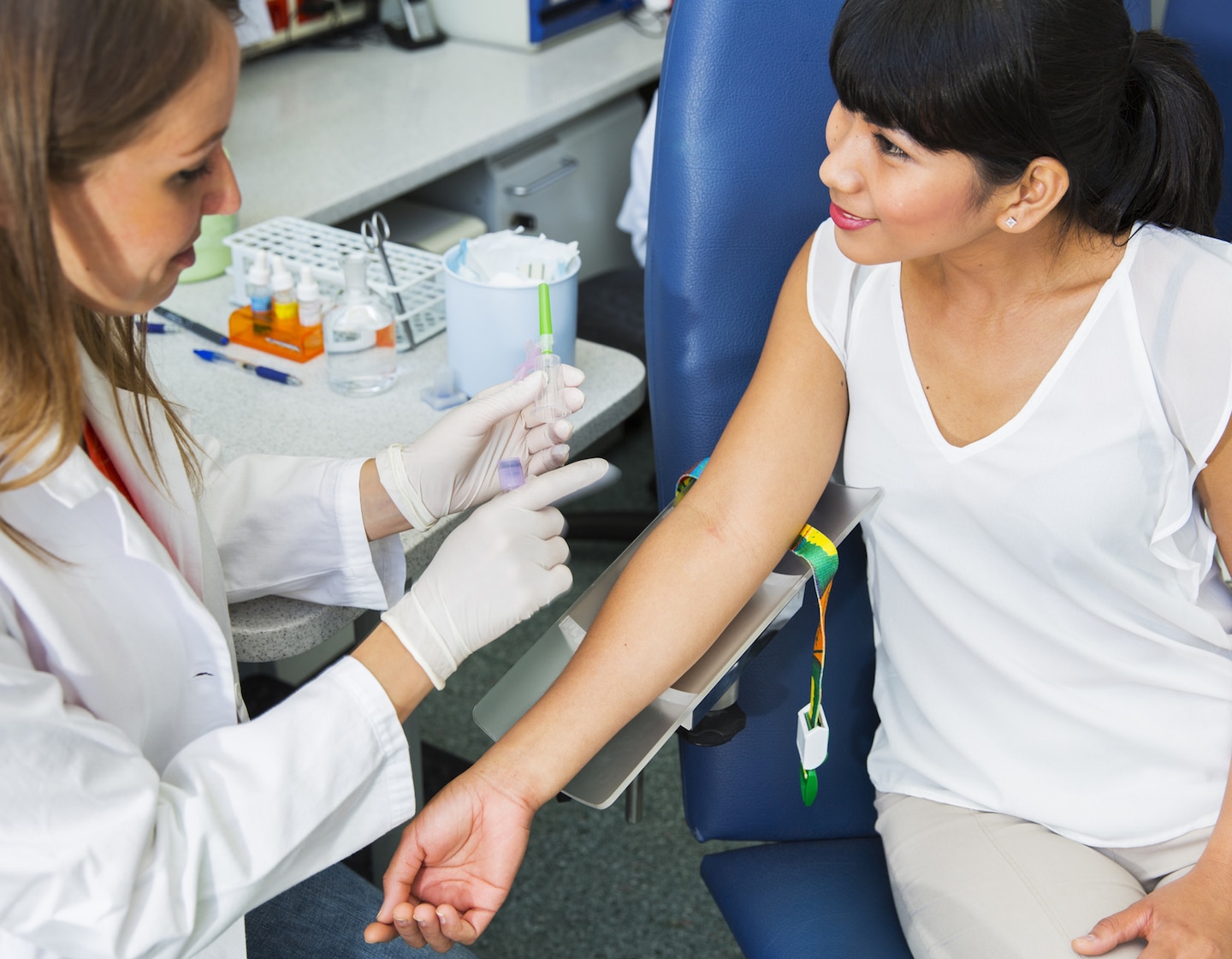 healthcare week kicks off helper appreciation month; here is a woman getting blood drawn as part of a medical checkup