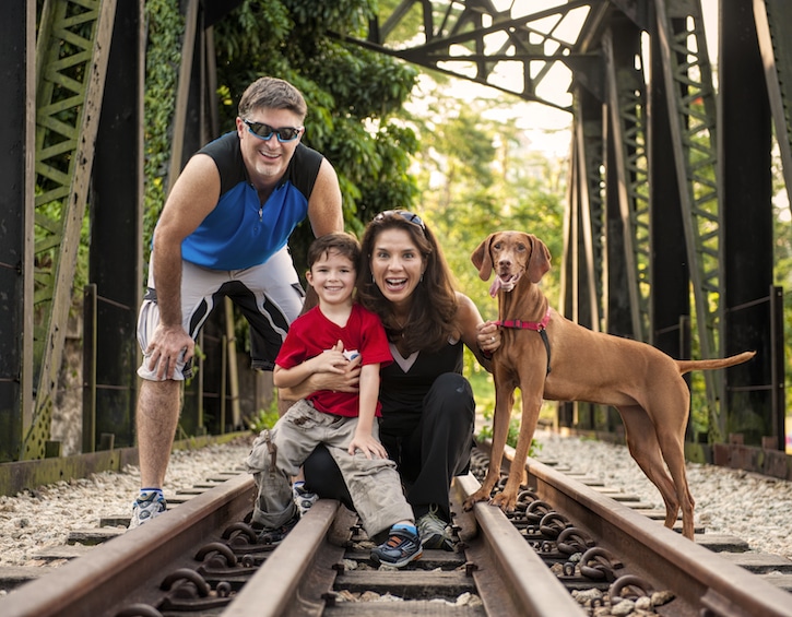 an outdoor family photoshoot in singapore on the old railway tracks by the green corridor by JJ Photography