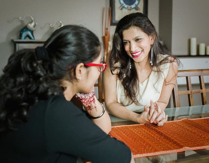 afshan banu talks with her daughter at the dining room table