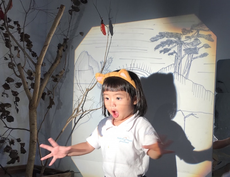 a child does role play at bucket house preschool