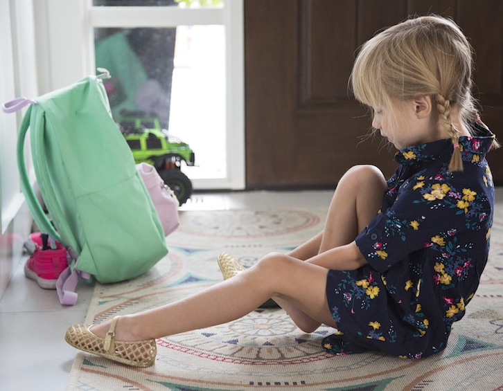 how to organise kids stuff child putting on shoes