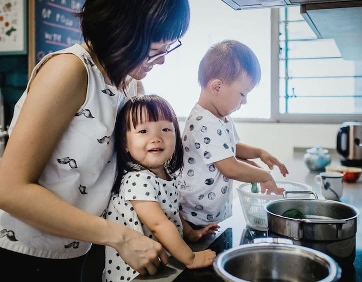 that mama artist illustrator gracie chai cooking in the kitchen with her children