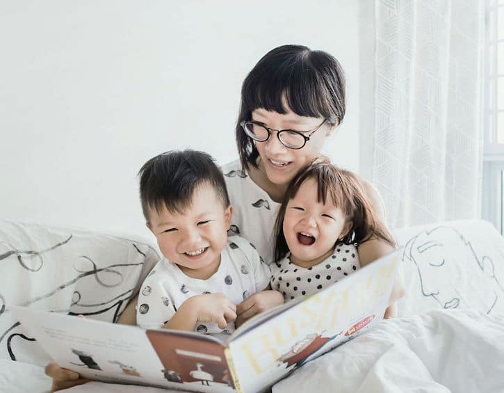 the children of artist gracie chai reads with her children