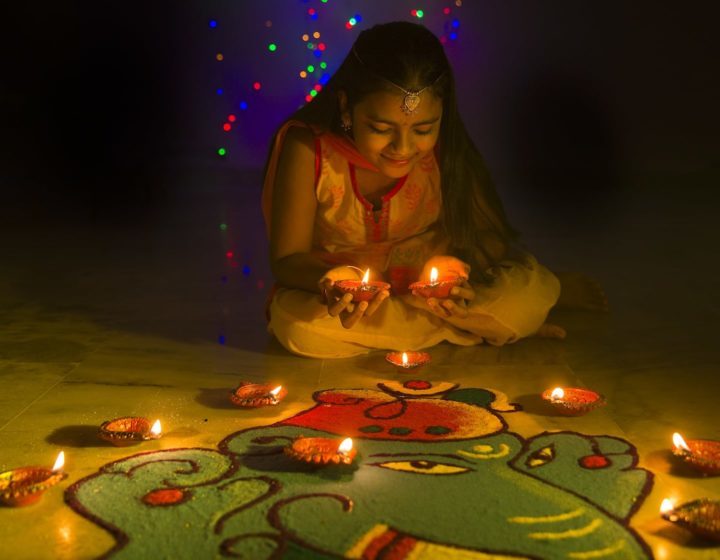 Celebrating Deepavali 2024 in Singapore - Girl making Rangoli and decorating with oil lamps for Deepavali