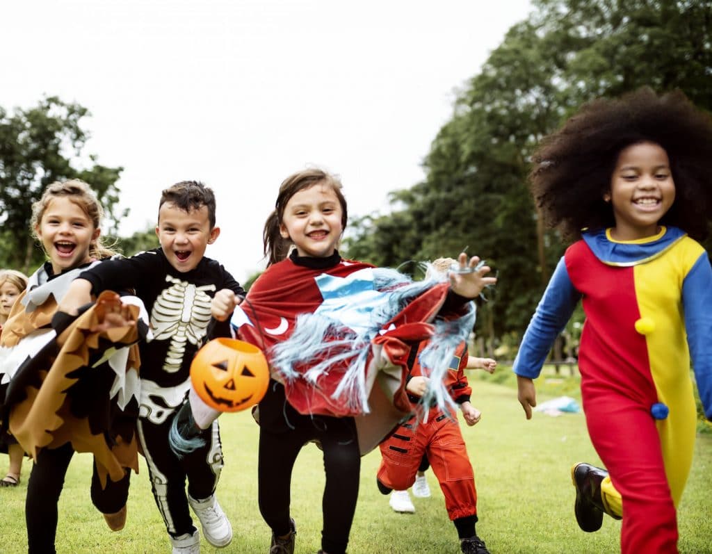 halloween kids trick or treating in costumes daytime