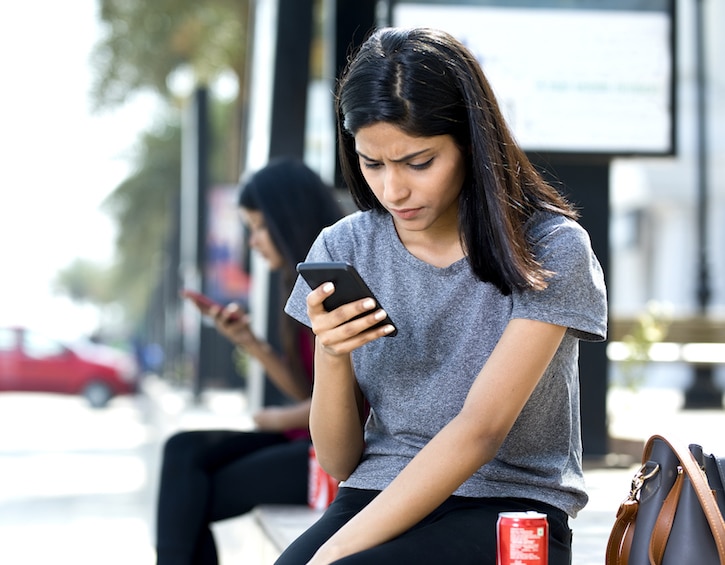 talking to kids about porn and texting worried teen girl on phone