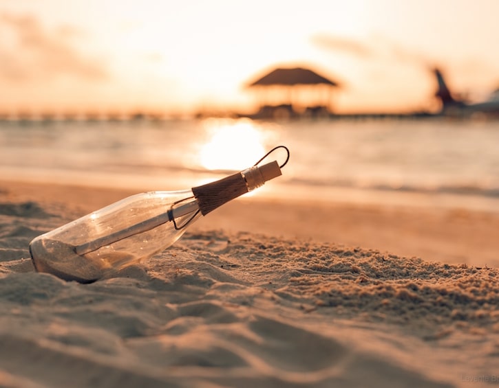 message in a bottle on the beach at maldives family resort lux south ari atoll 