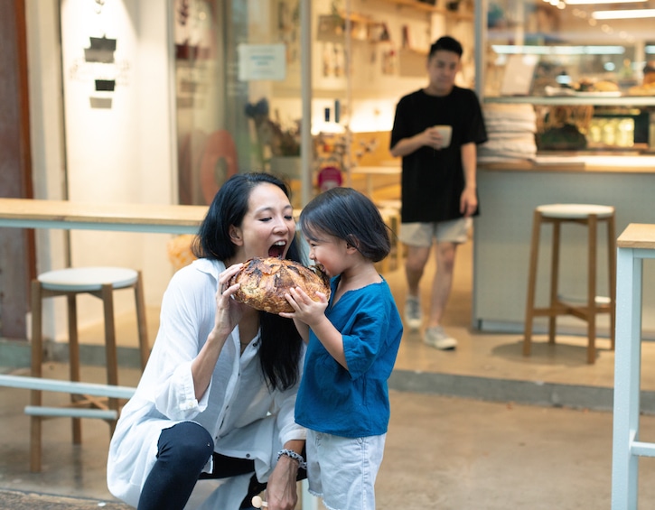 min siah starter lab bakery co founder with her son eating bread