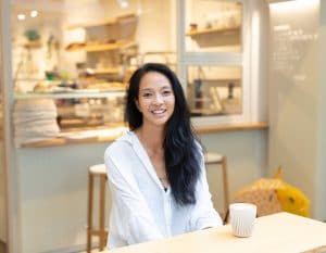 min siah starter lab bakery co founder sitting at her cafe