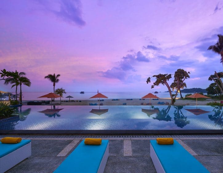 sunset at the pool and beach at cassia bintan resort for family