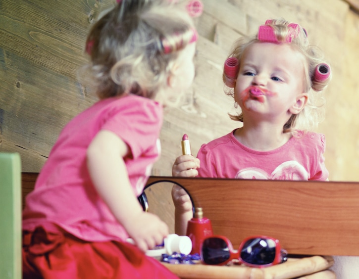 makeup for kids little girl wearing lipstick and curlers