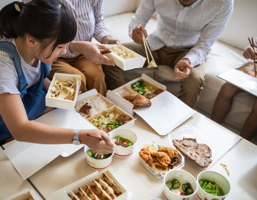 Taiwanese family eating Chinese take out food at home