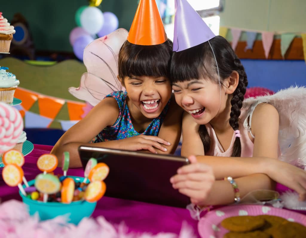 Kids using digital tablet during birthday party