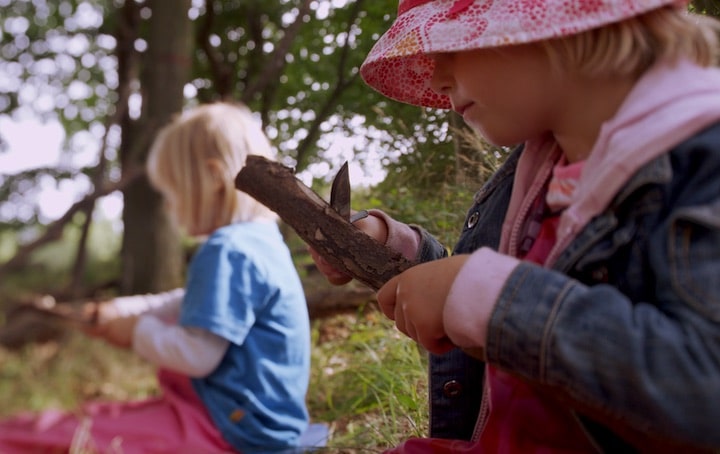 natureplay film little girls carving wood with knives