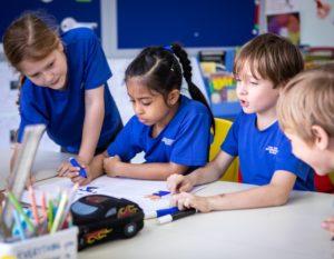 primary school art students doing in-class learning at owis