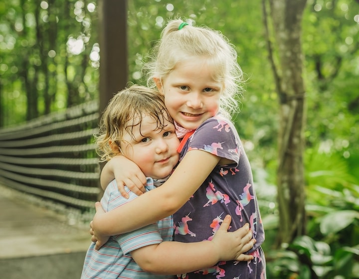 parenting in singapore siblings hug love