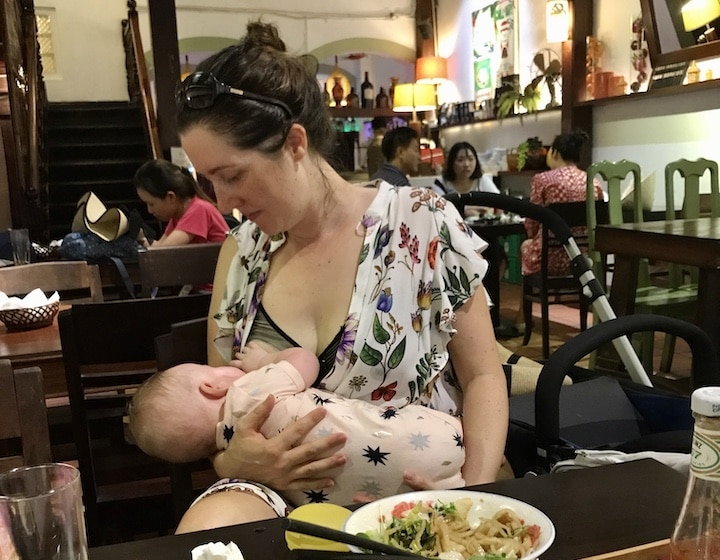 when to stop breastfeeding woman feeding baby in restaurant