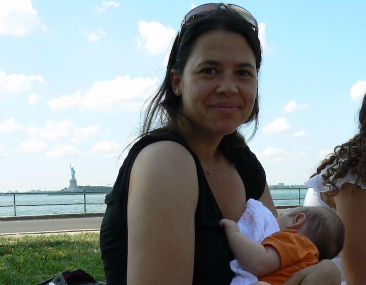 when to stop breastfeeding woman feeding baby in park