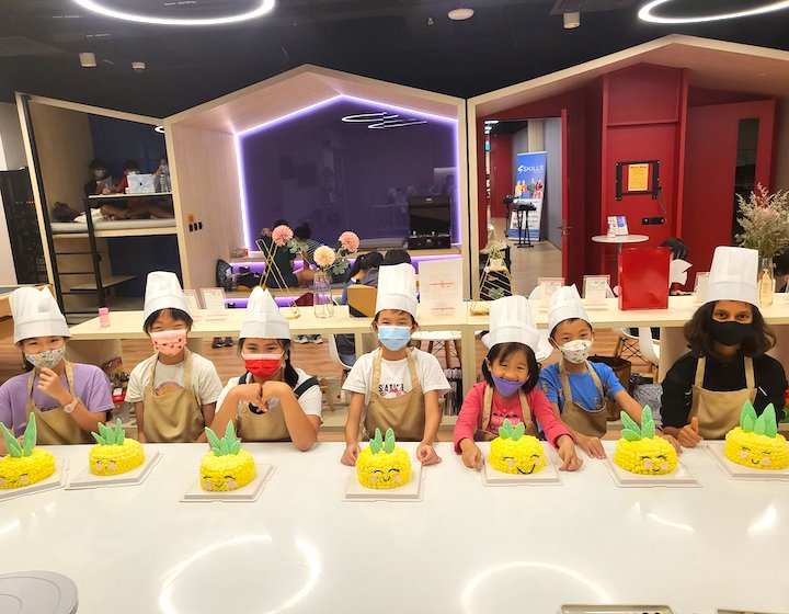 school holiday camps singapore ray educators kid bakers with cakes