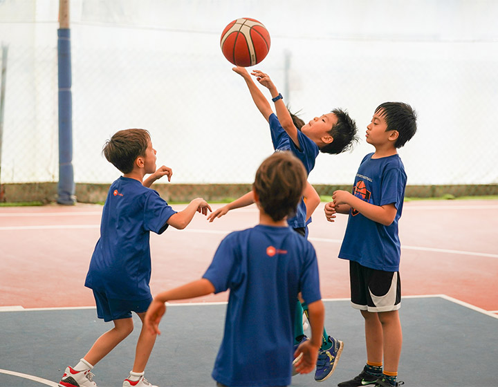 summer school holiday camps; children playing basketball